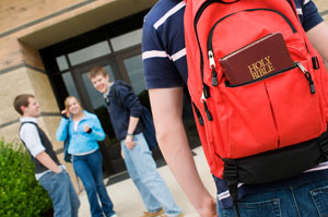 Child carrying bible to school in a backpack